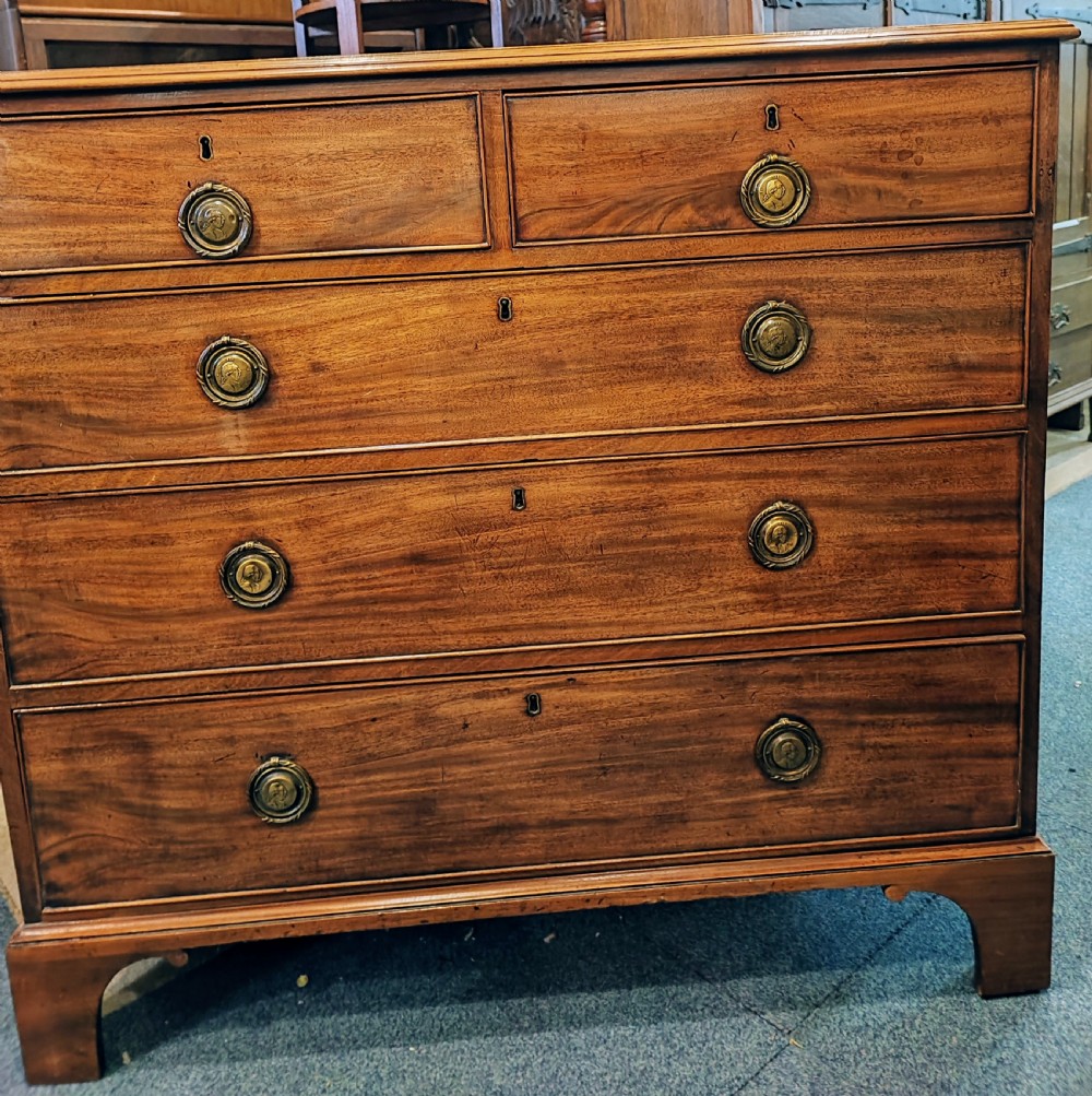 A rare Georgian mahogany chest of drawers,with original handles depicts the profile of King George III. View XI