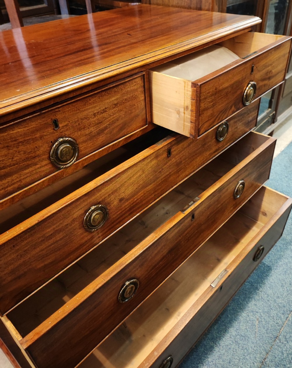 A rare Georgian mahogany chest of drawers,with original handles depicts the profile of King George III. View XII