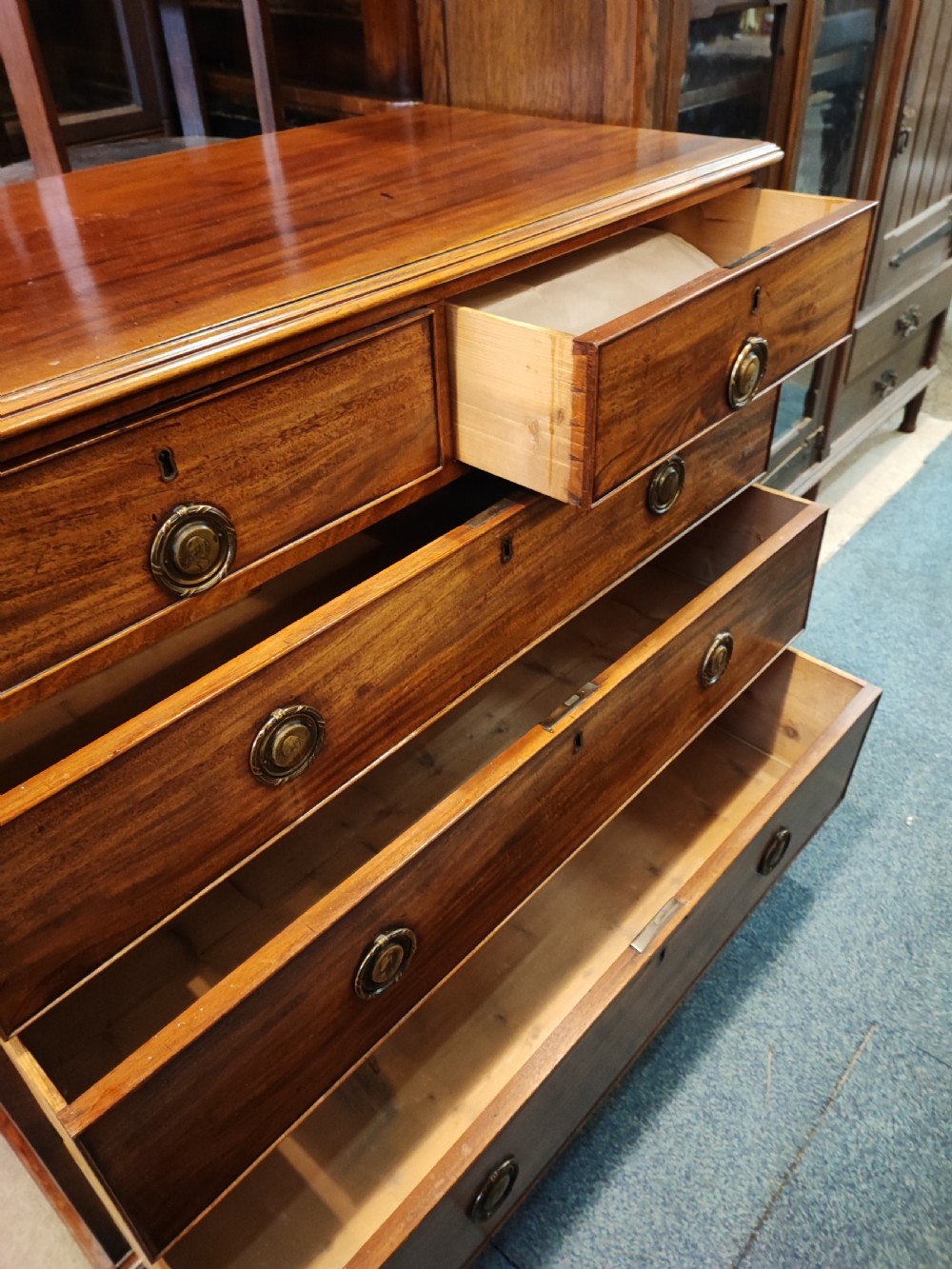 A rare Georgian mahogany chest of drawers,with original handles depicts the profile of King George III. View XV
