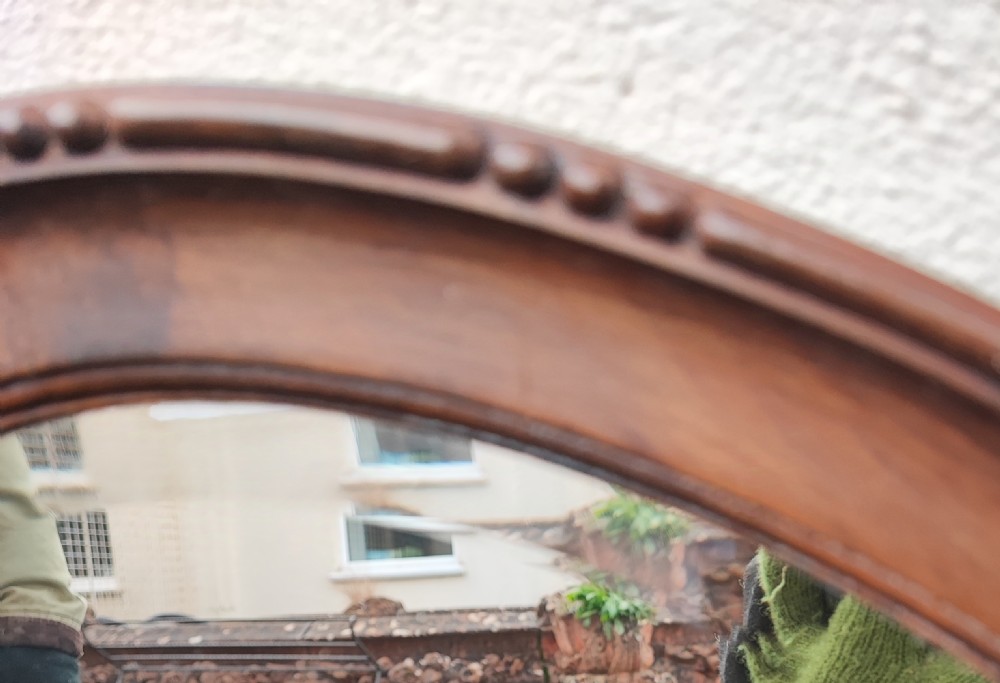 Large antique oval mahogany beveled mirror  View II