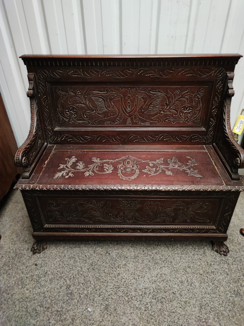 An antique italian carved walnut hall bench or settle