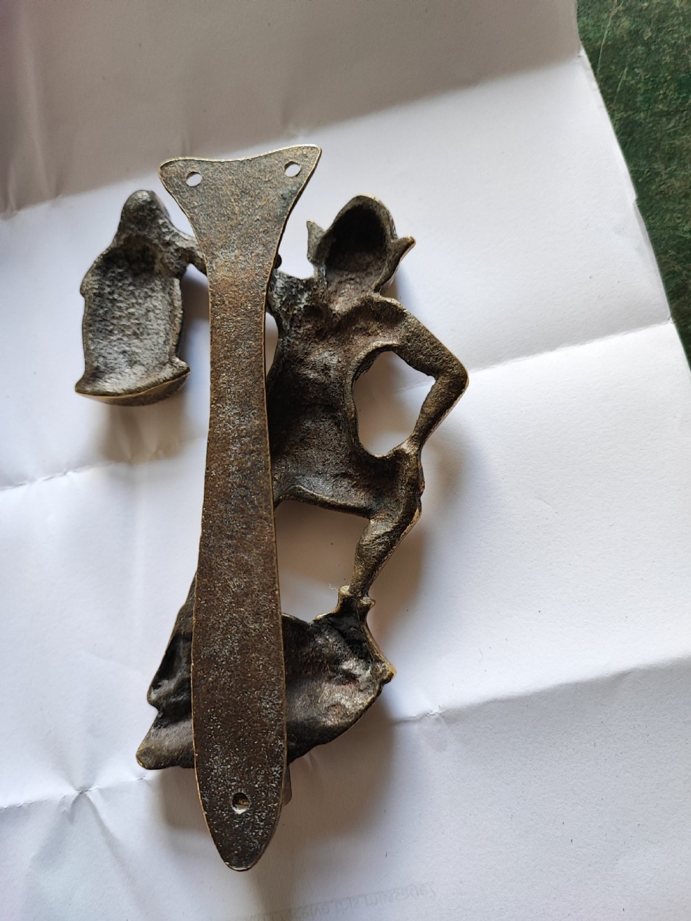 An antique solid brass door knocker sculpted in the shape of a whimsical imp holding a lantern while standing atop a mushroom base. View IX