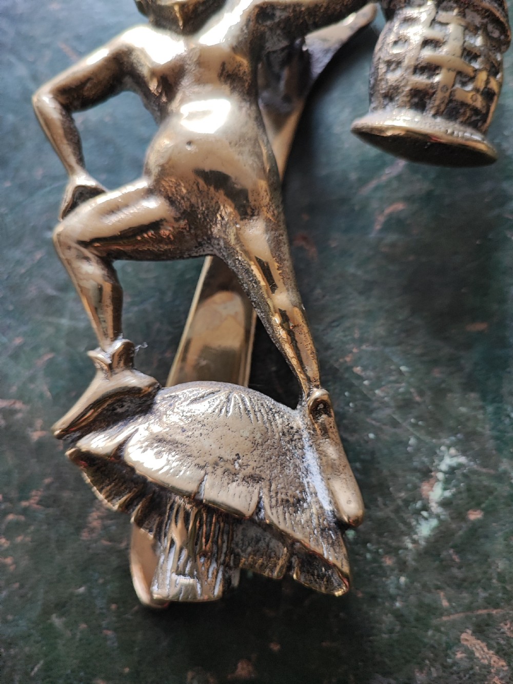 An antique solid brass door knocker sculpted in the shape of a whimsical imp holding a lantern while standing atop a mushroom base. View X
