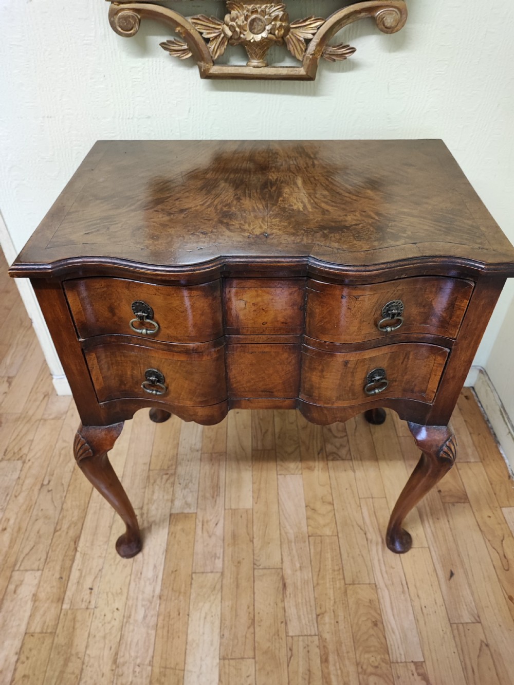 Antique walnut serpentine side table in the Queen Anne style.