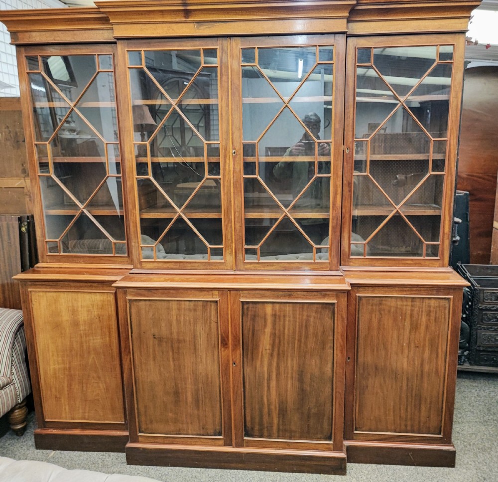 Antique mahogany breakfront bookcase in the George III style.