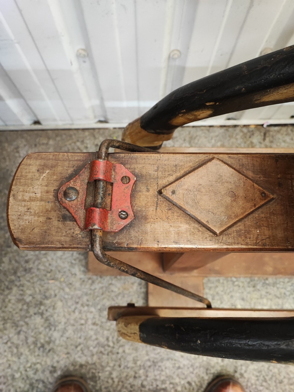 A large antique carved wooden rocking horse with a dappled painted finish, leather saddle, horsehair mane, and tail, mounted on a wooden safety stand. View VIII