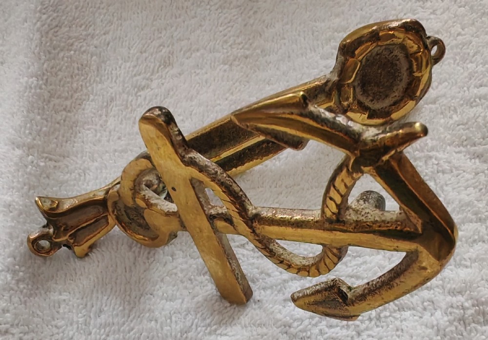 A solid cast brass door knocker crafted in the shape of a fouled anchor with rope detailing and an integrated striker. View V