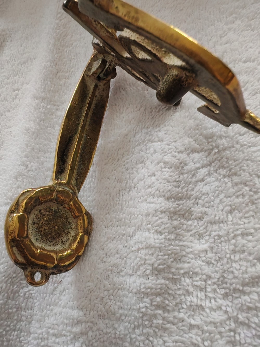 A solid cast brass door knocker crafted in the shape of a fouled anchor with rope detailing and an integrated striker. View IX