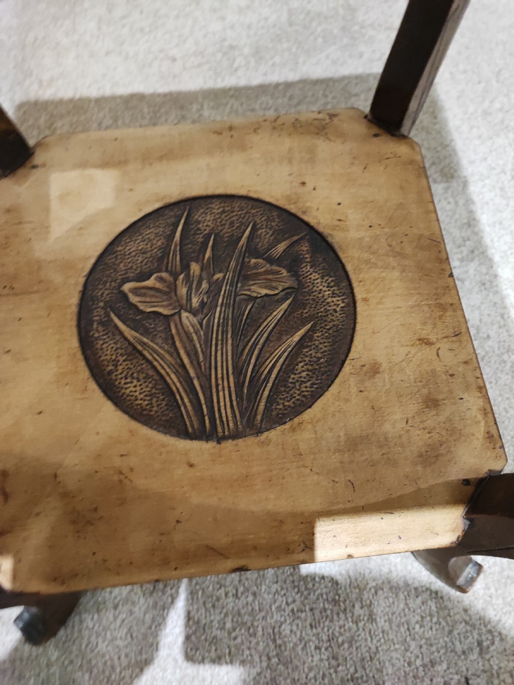 A square Arts and Crafts wooden side table featuring carved iris botanical motifs, bamboo-style edge moulding, shaped legs, and a carved lower shelf. View VII