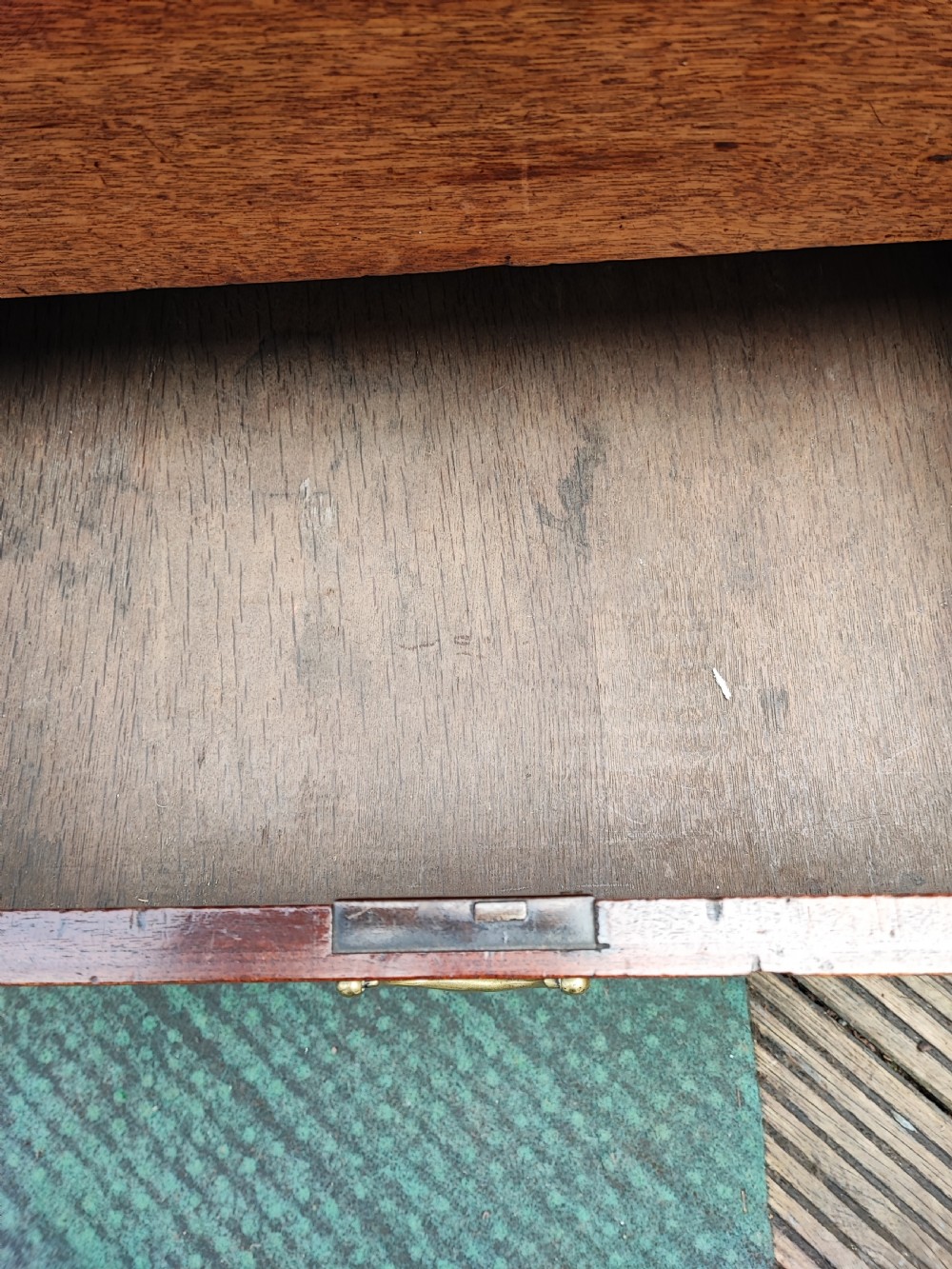 A George III mahogany storage trunk featuring a hinged top lid, two lower drawers, and brass batwing escutcheon handles. View XIV