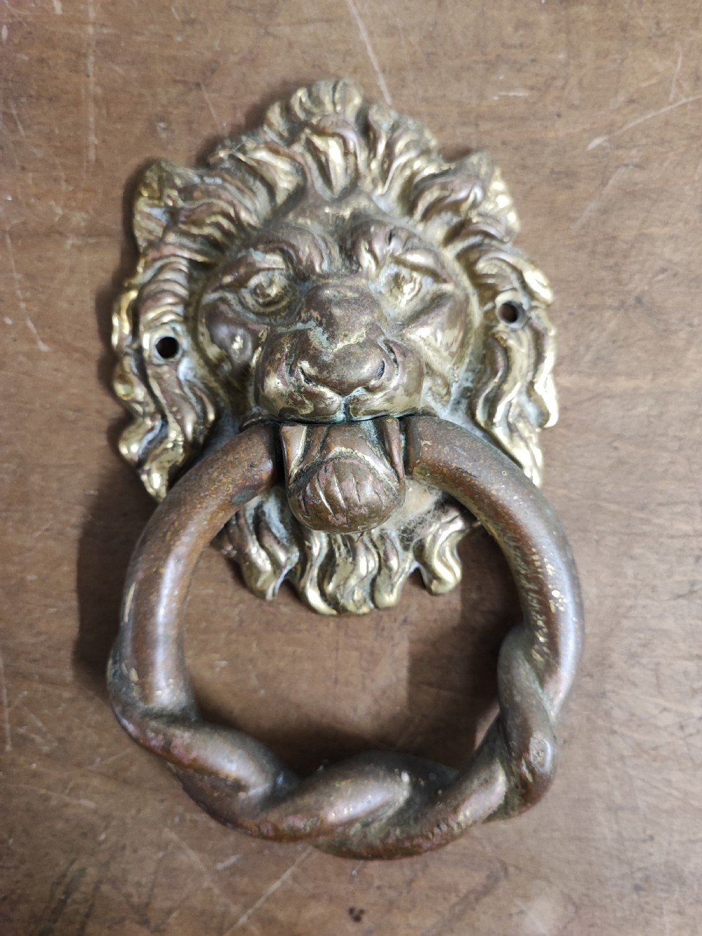 Antique brass lion mask door knocker.