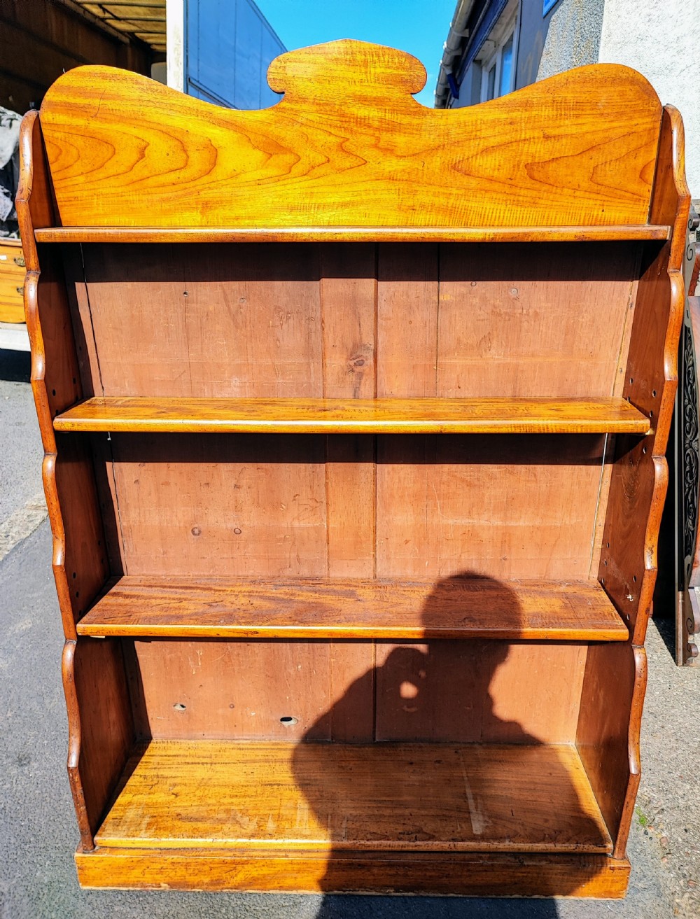 An antique pine open bookcase featuring a shaped pediment top, wavy sides, and four open display shelves. View II