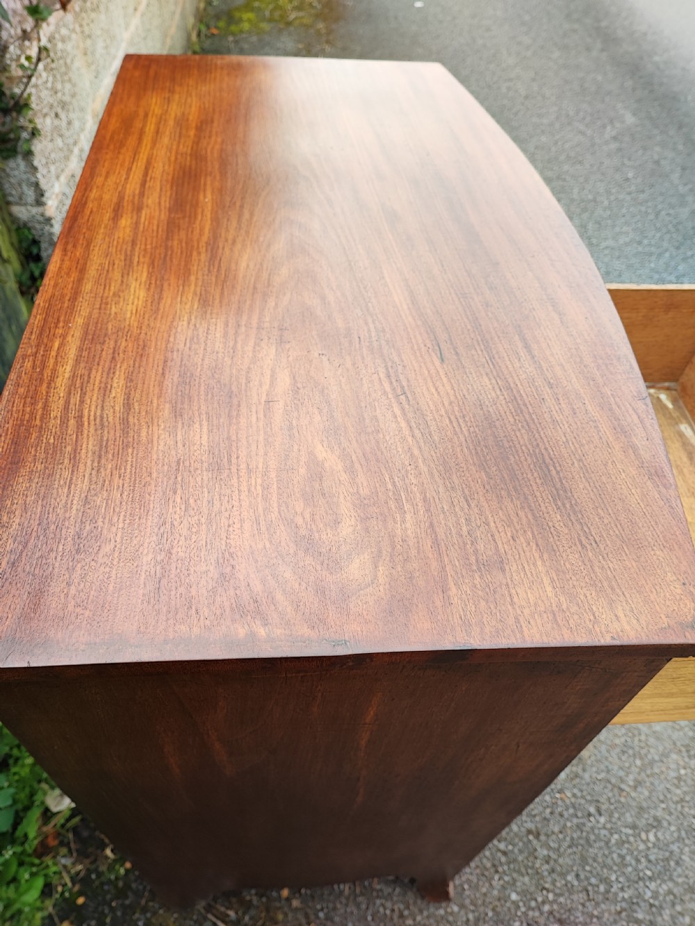 A small Regency mahogany bowfront chest of drawers. View IV