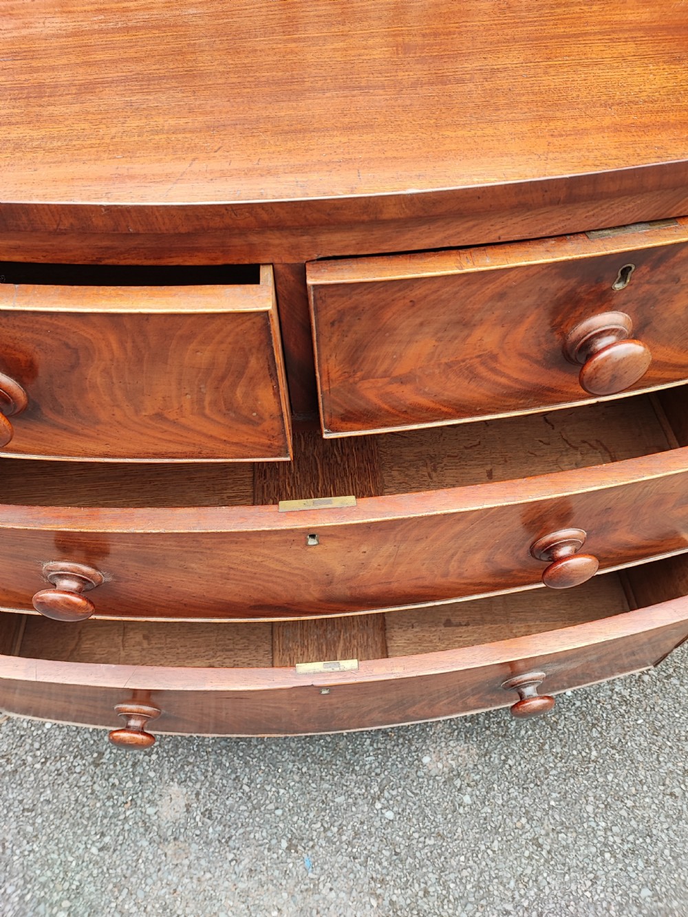 A small Regency mahogany bowfront chest of drawers. View V