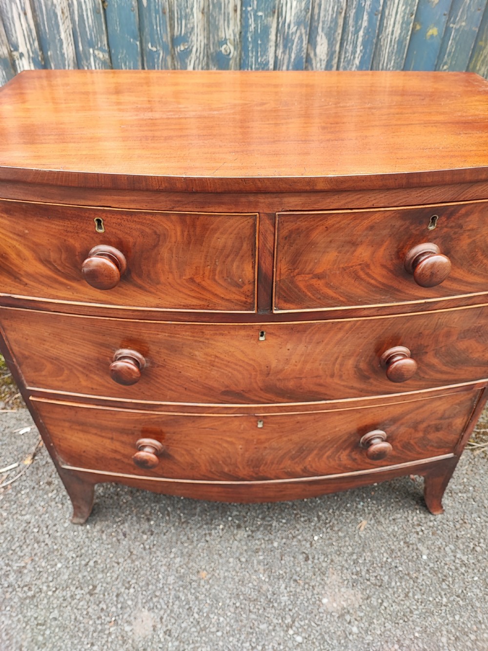 A small Regency mahogany bowfront chest of drawers. View VII