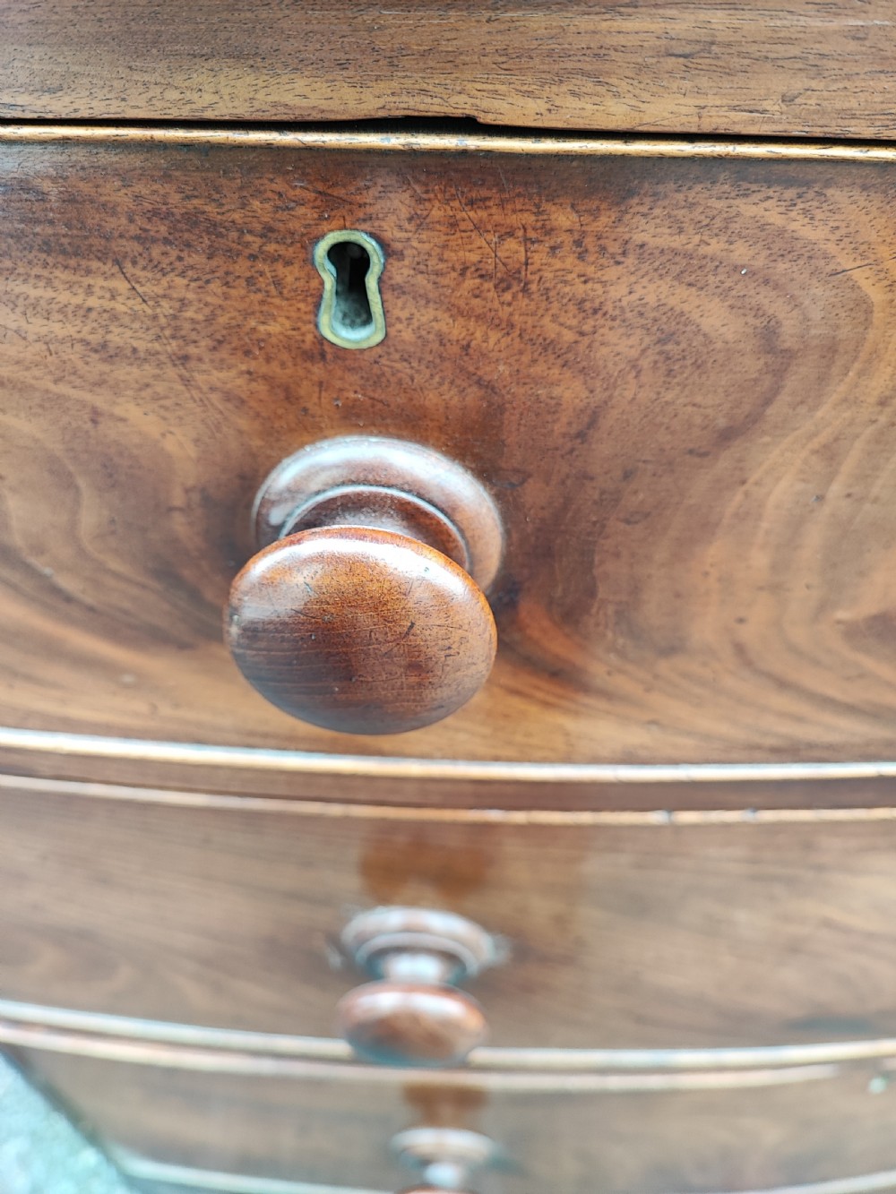 A small Regency mahogany bowfront chest of drawers. View VIII
