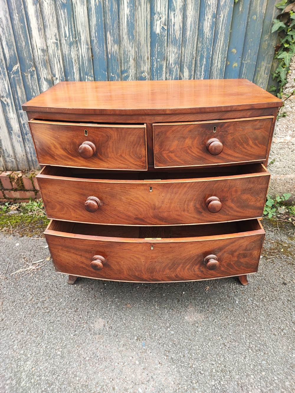 A small Regency mahogany bowfront chest of drawers. View IX