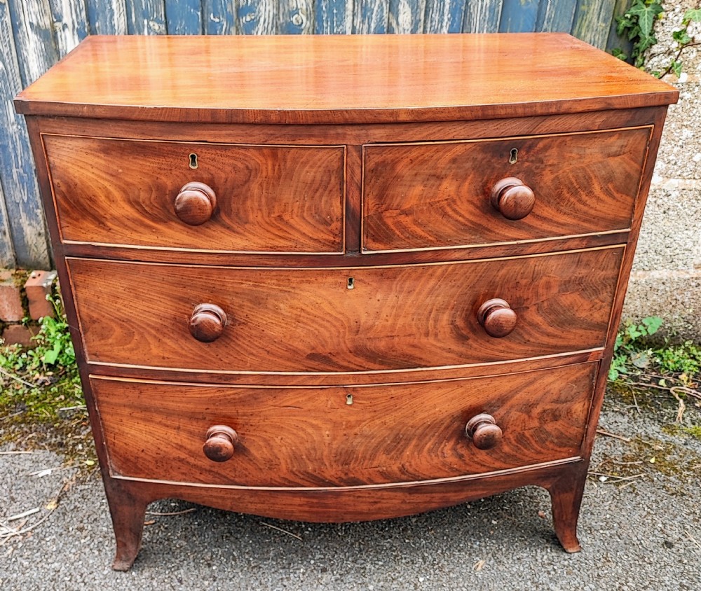 A small Regency mahogany bowfront chest of drawers.