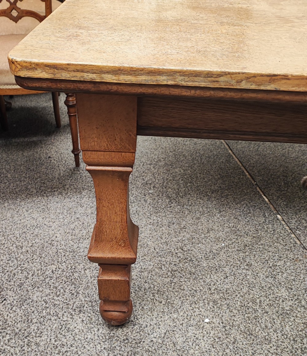 Antique golden oak 2 leaf extending dining table. View V