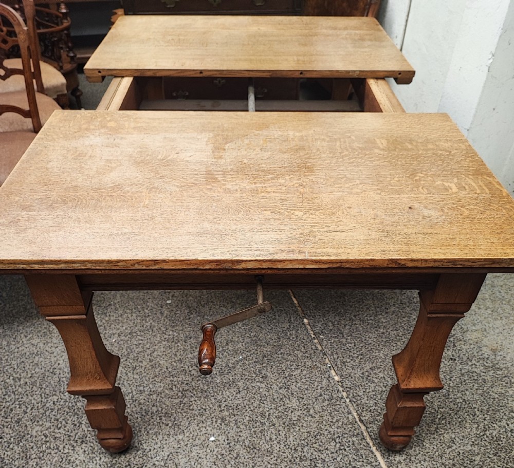 Antique golden oak 2 leaf extending dining table. View VII
