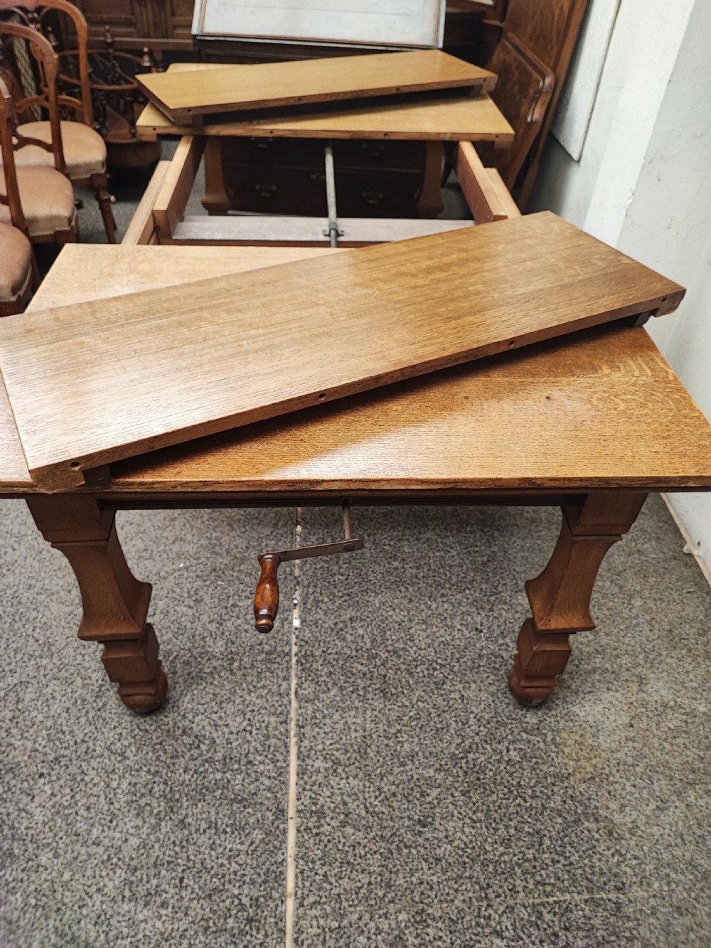 Antique golden oak 2 leaf extending dining table. View XIV