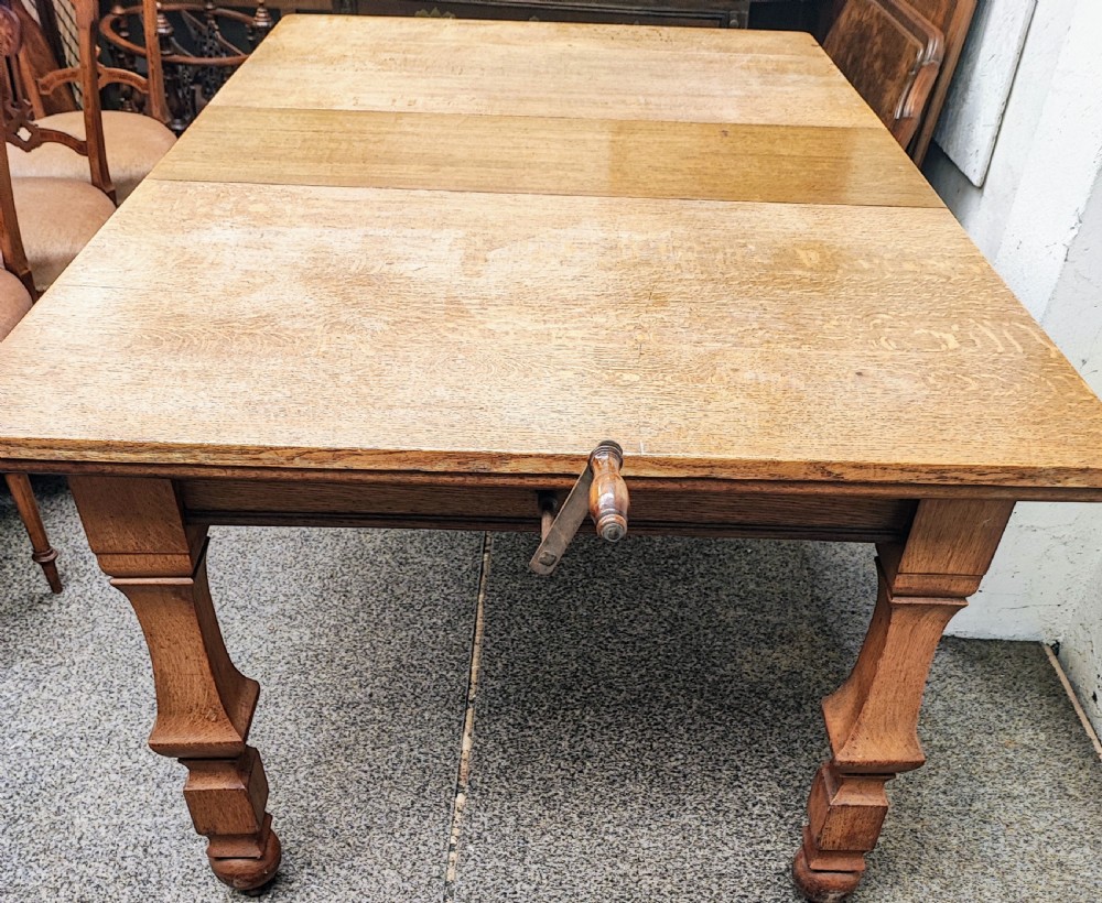 Antique golden oak 2 leaf extending dining table. View XVIII