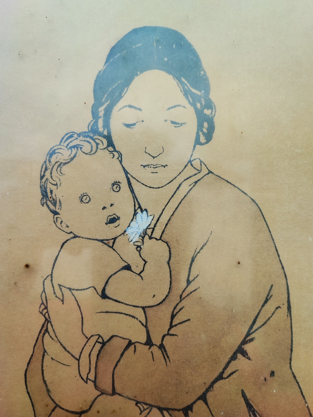 An antique framed paper print depicting a seated mother holding a child in a pastoral landscape alongside two lambs and a birch tree. View IV