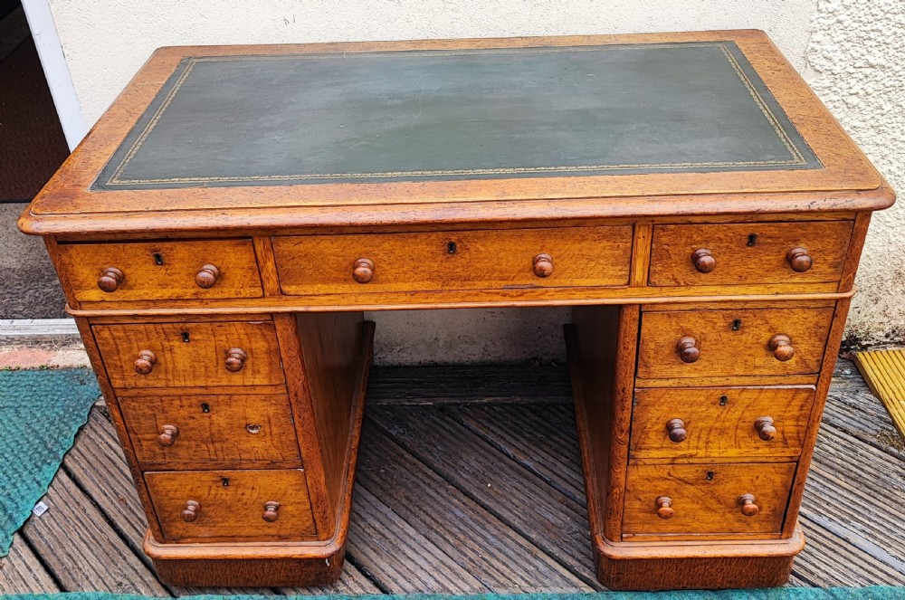 A Victorian oak pedestal desk.