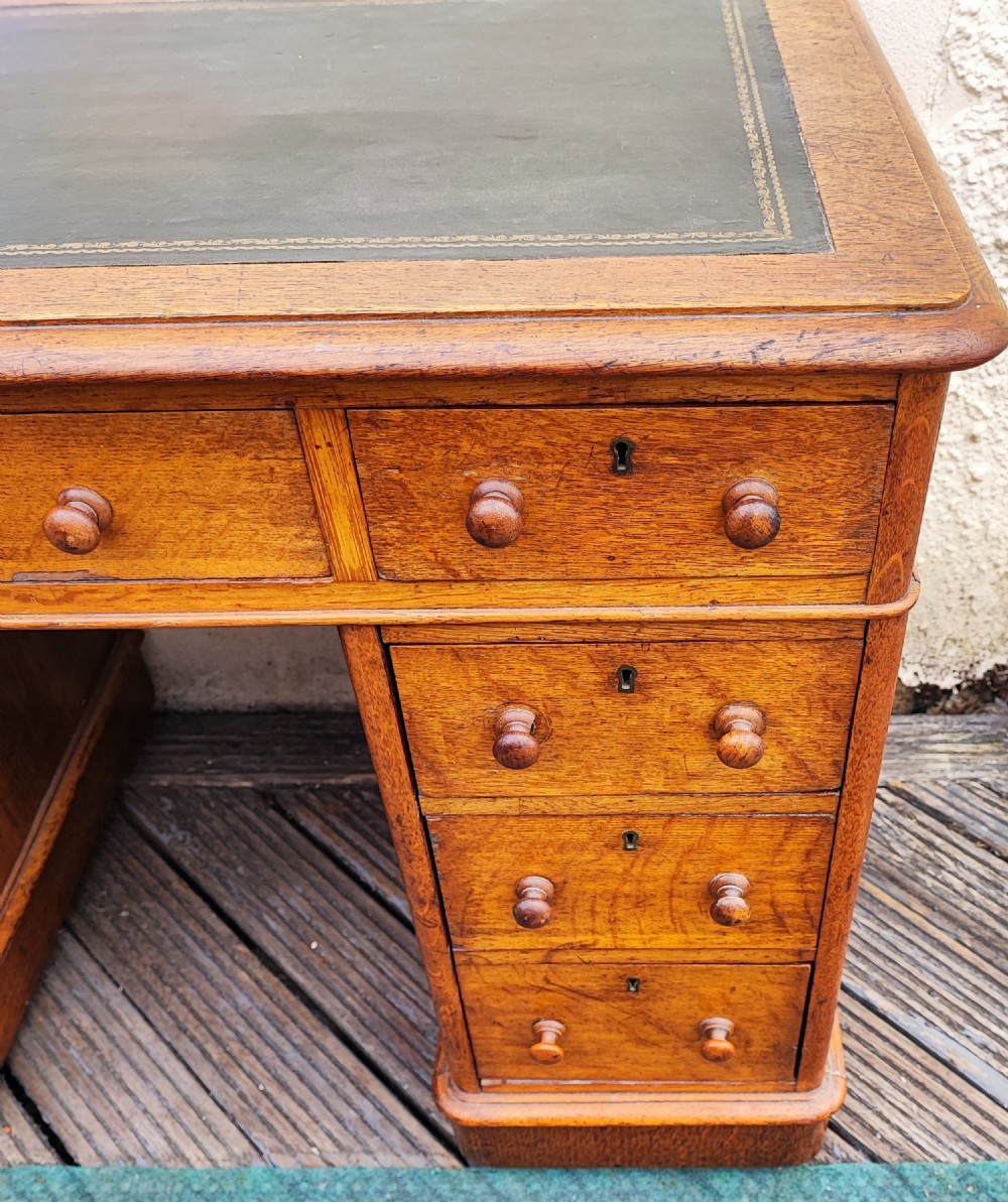 A Victorian oak pedestal desk. View VII
