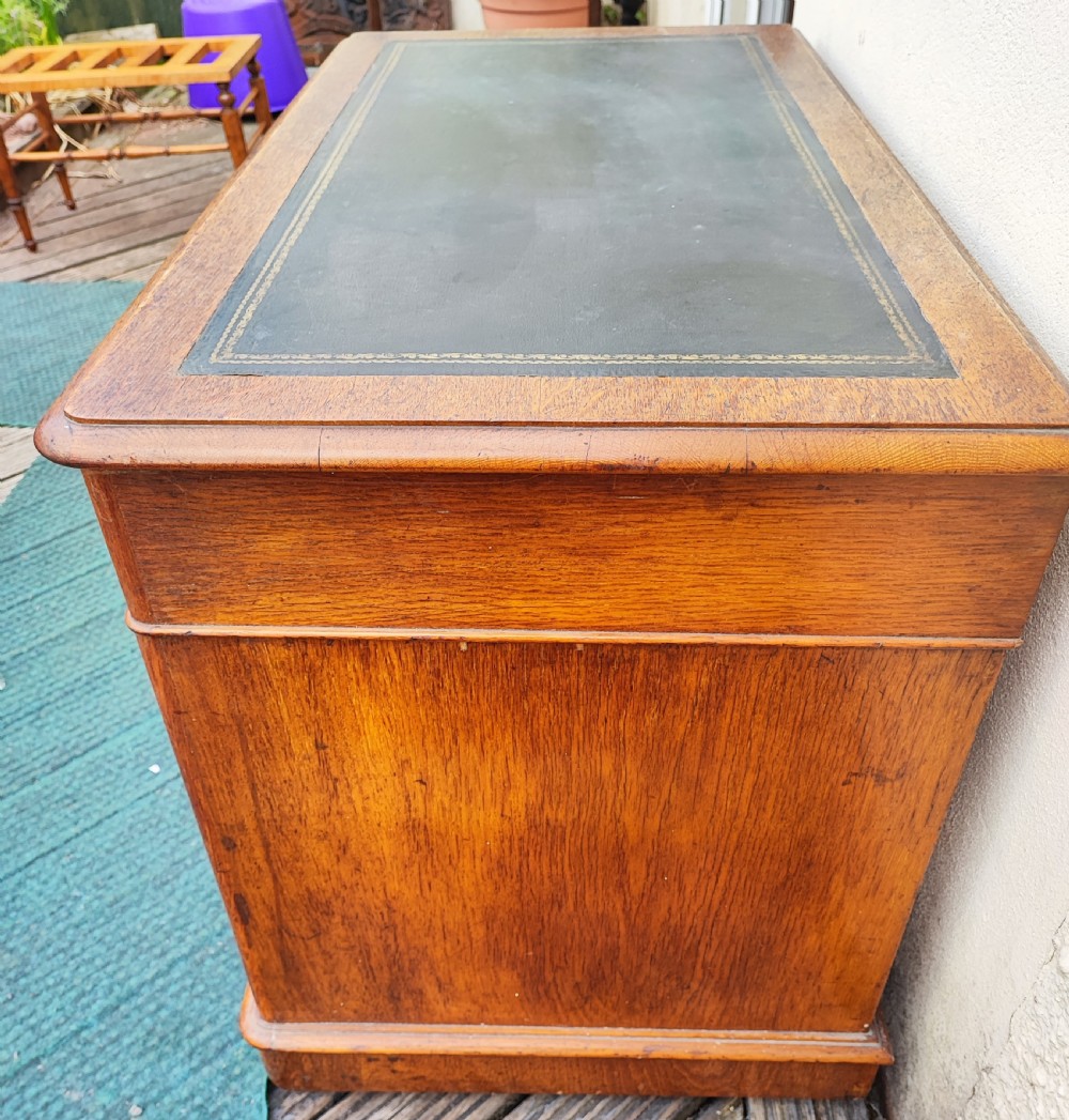 A Victorian oak pedestal desk. View VIII