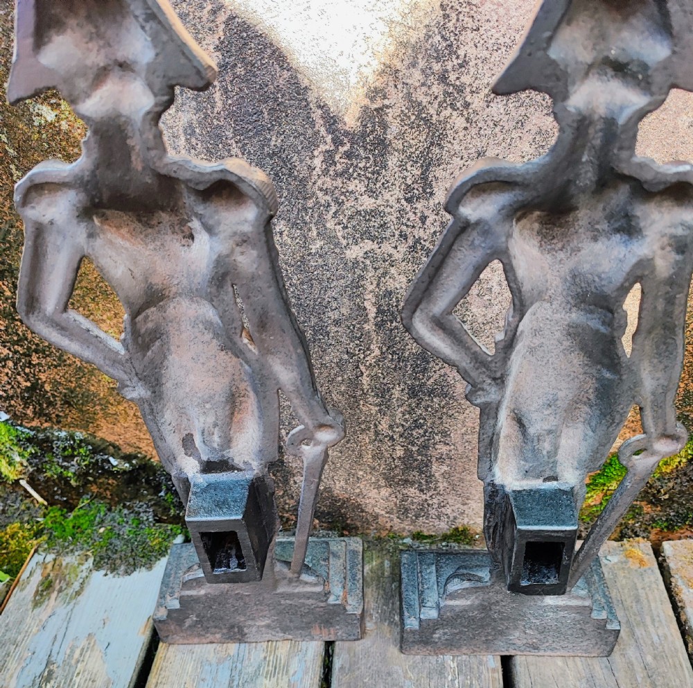 A pair of cast iron Victorian doorstops depicted as military officers in full uniform standing on stepped bases. View II