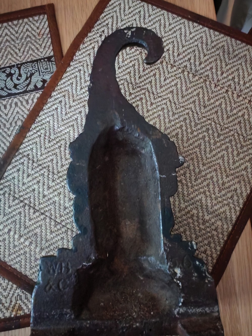 A dark brown cast iron doorstop featuring a sculpted bust of a bearded folklore figure wearing a curved pointed hat. View VIII