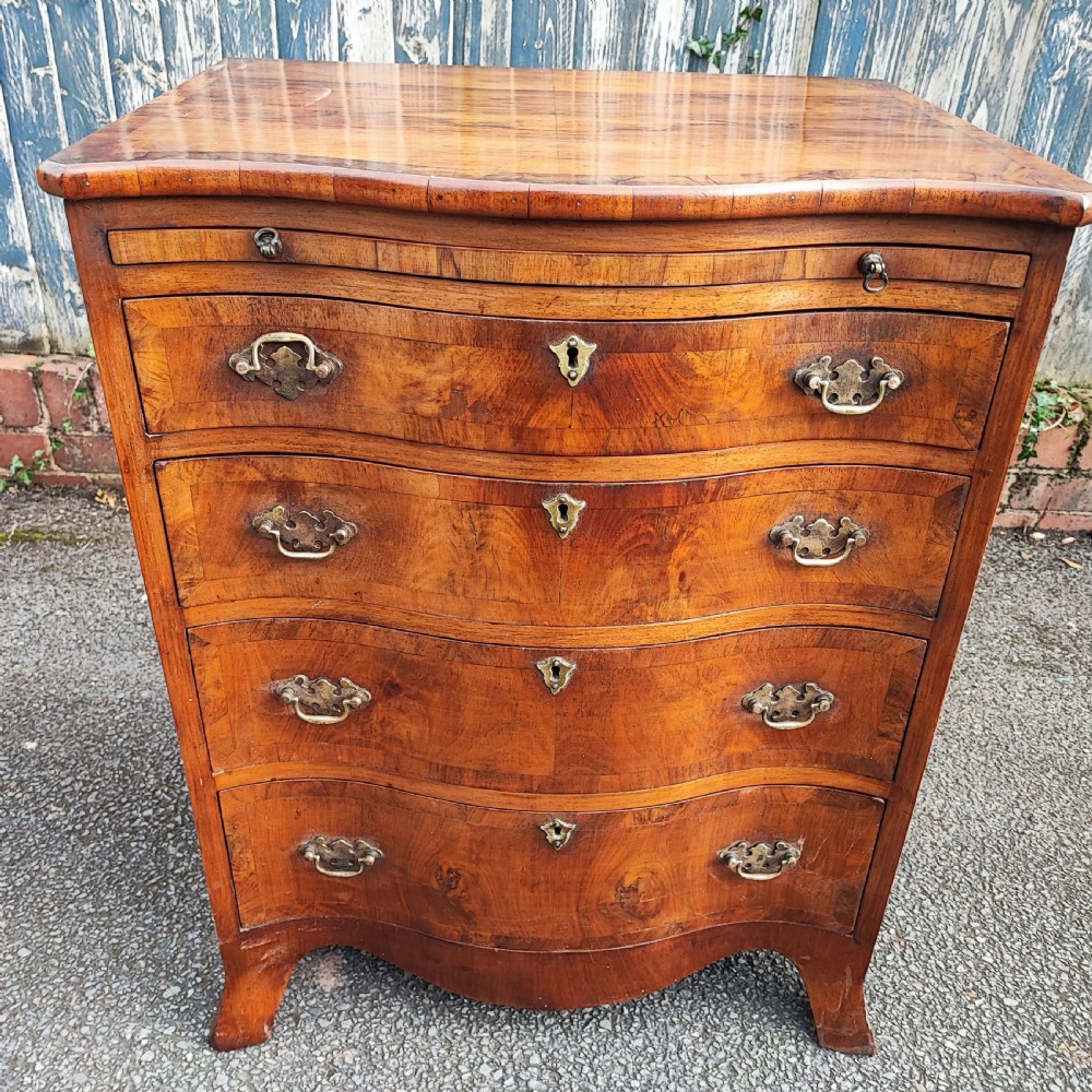 A quality serpentine walnut chest of drawers View IV