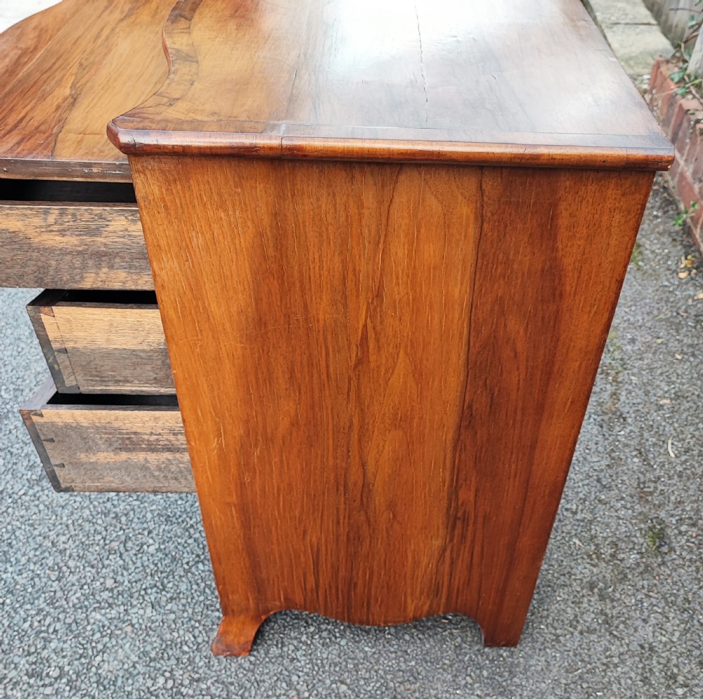 A quality serpentine walnut chest of drawers View VII