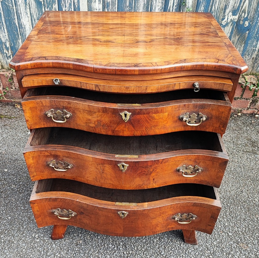 A quality serpentine walnut chest of drawers View VIII