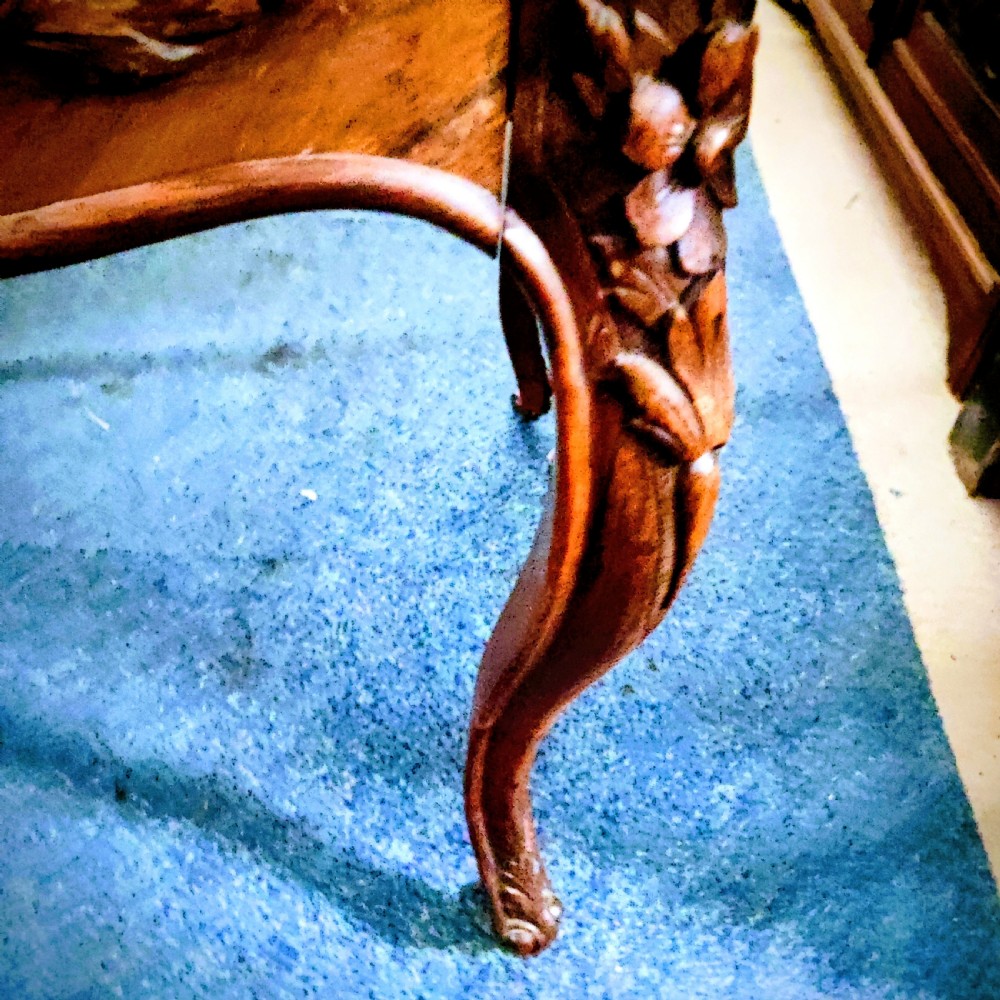 An antique French rosewood side table featuring a parquetry top with extendable side leaves, carved floral apron details, and slender cabriole legs. View II