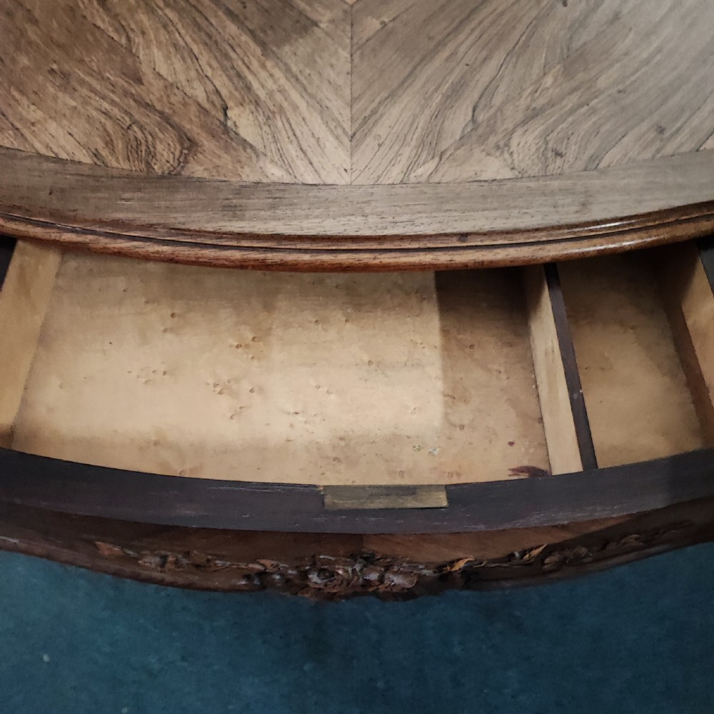 An antique French rosewood side table featuring a parquetry top with extendable side leaves, carved floral apron details, and slender cabriole legs. View V