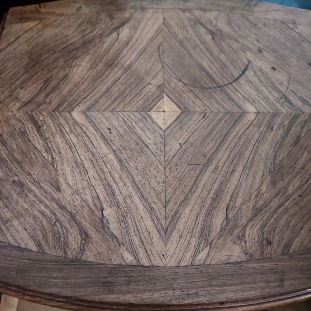 An antique French rosewood side table featuring a parquetry top with extendable side leaves, carved floral apron details, and slender cabriole legs. View VI