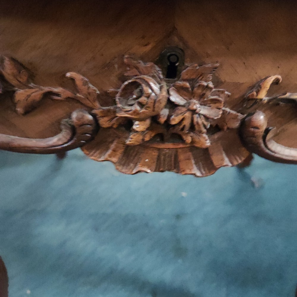 An antique French rosewood side table featuring a parquetry top with extendable side leaves, carved floral apron details, and slender cabriole legs. View IX