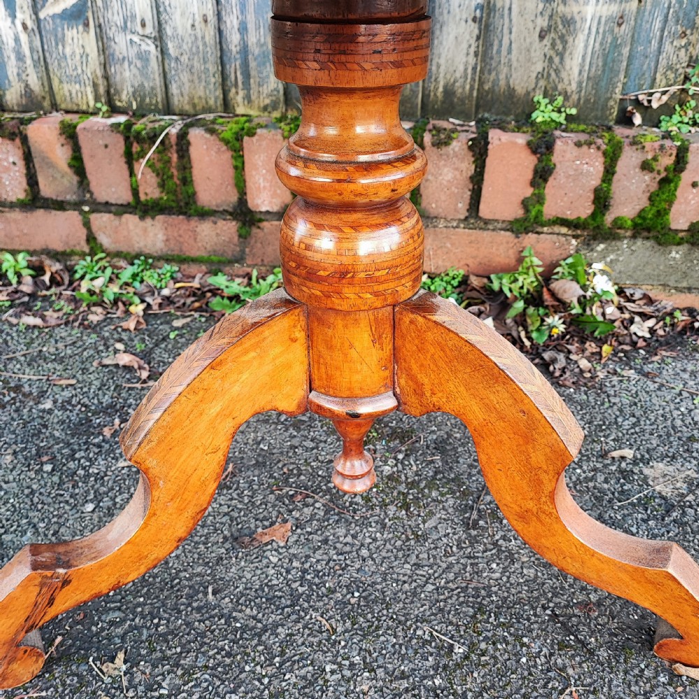 An octagonal wood low table featuring an intricate geometric starburst marquetry pattern on top, set on curved legs. View VI