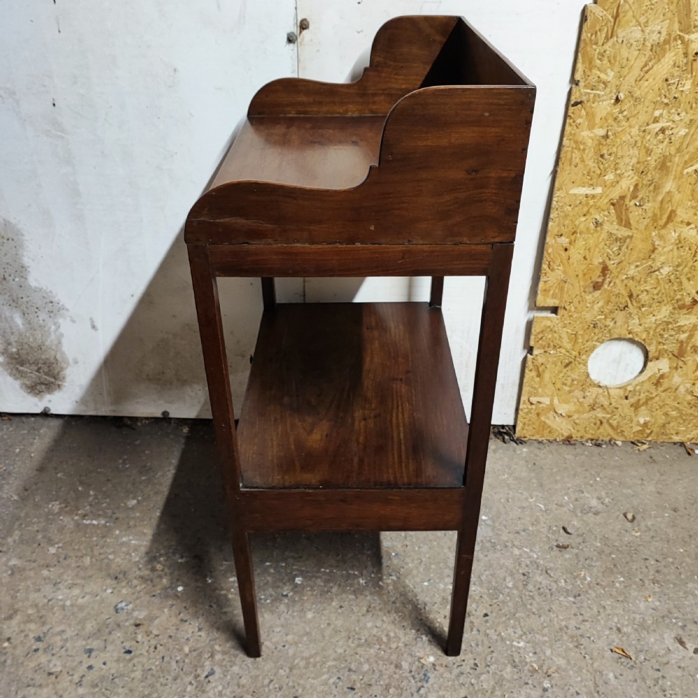 A Georgian mahogany bedside table featuring a high gallery tray top, an open middle shelf, a single drawer with brass knobs, and straight legs. View III