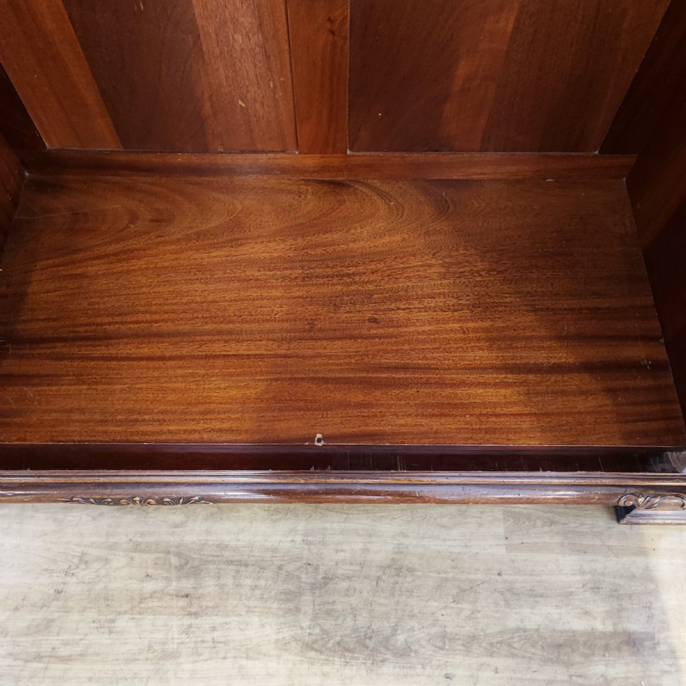 An Edwardian flame mahogany three-door wardrobe featuring carved rope twist moulding and carved bracket feet. View VIII