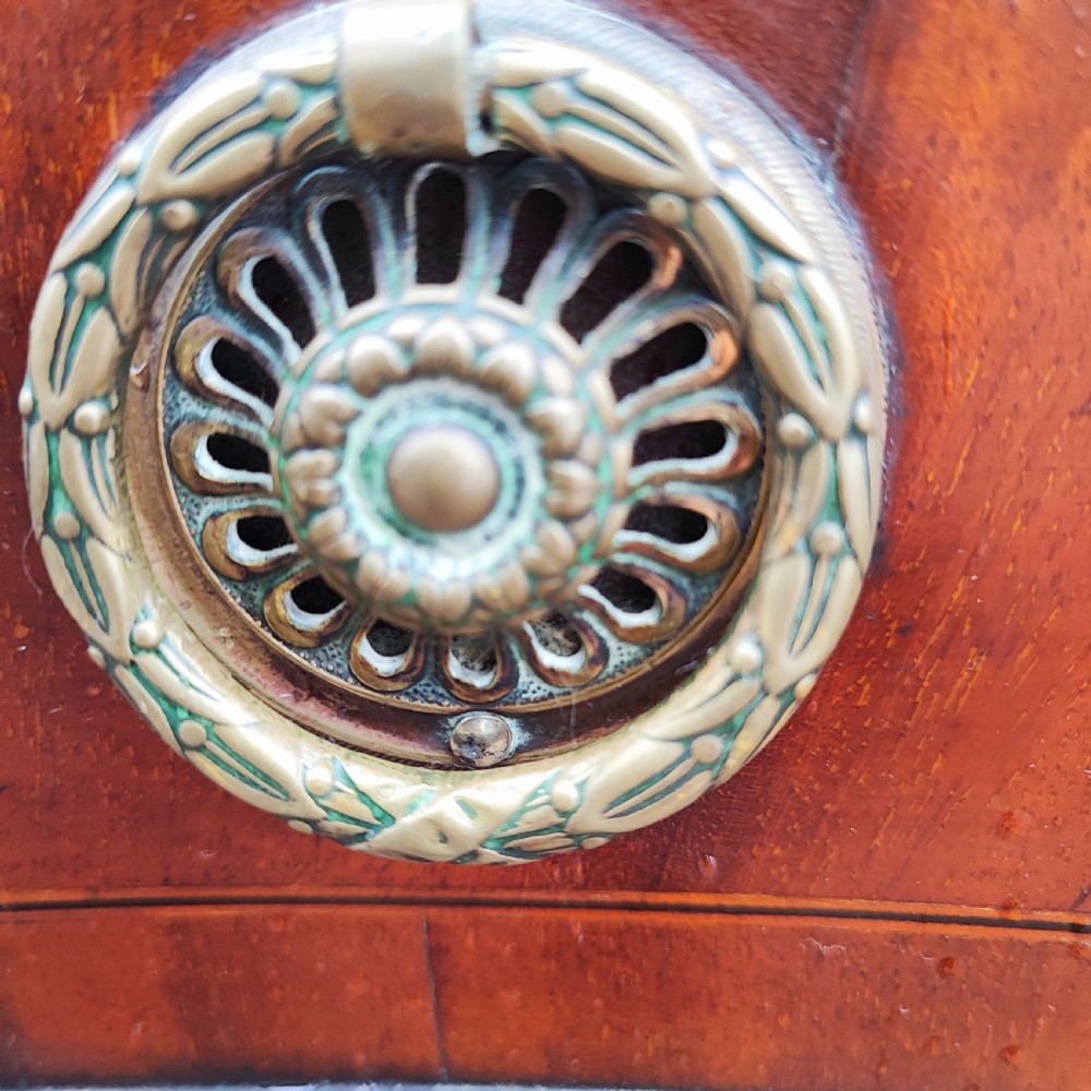 A George III style serpentine mahogany sideboard featuring marquetry inlay, brass ring handles, an arched central drawer, and square tapered legs. View VI