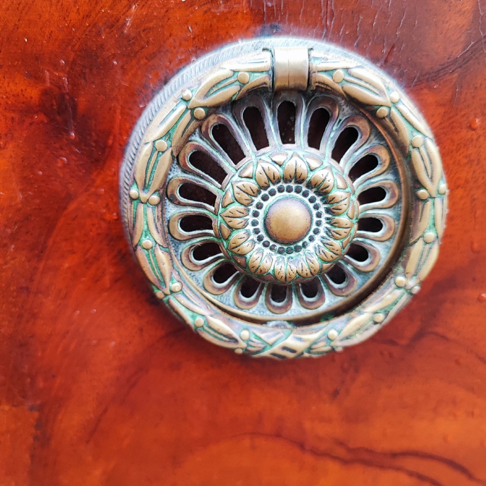 A George III style serpentine mahogany sideboard featuring marquetry inlay, brass ring handles, an arched central drawer, and square tapered legs. View XII