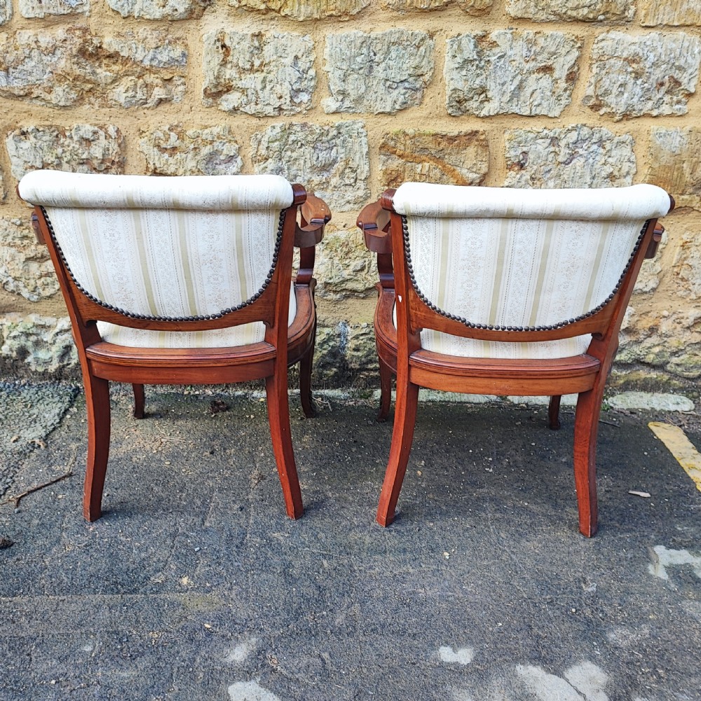 A pair of antique mahogany armchairs featuring cream and gold striped upholstery, curved cabriole legs, brass embellishments, and metal trim. View III