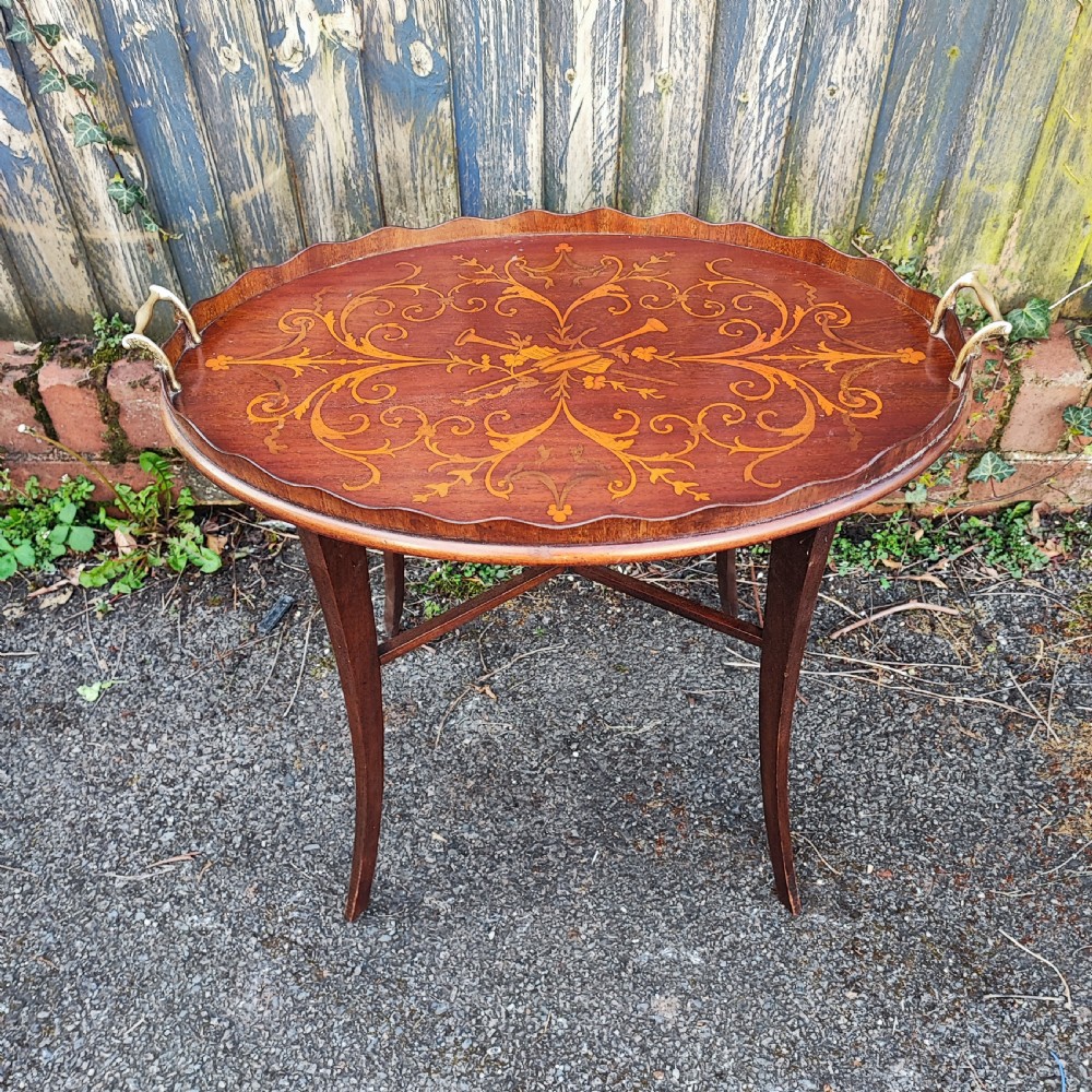 An oval mahogany side table featuring intricate floral marquetry inlay, a scalloped gallery rim, brass side handles, and slender curved legs. View IV