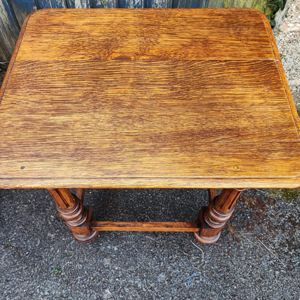 An antique oak low side table featuring fluted turned legs, square block joints, lower perimeter stretchers, and a rectangular top with moulded edges. View III