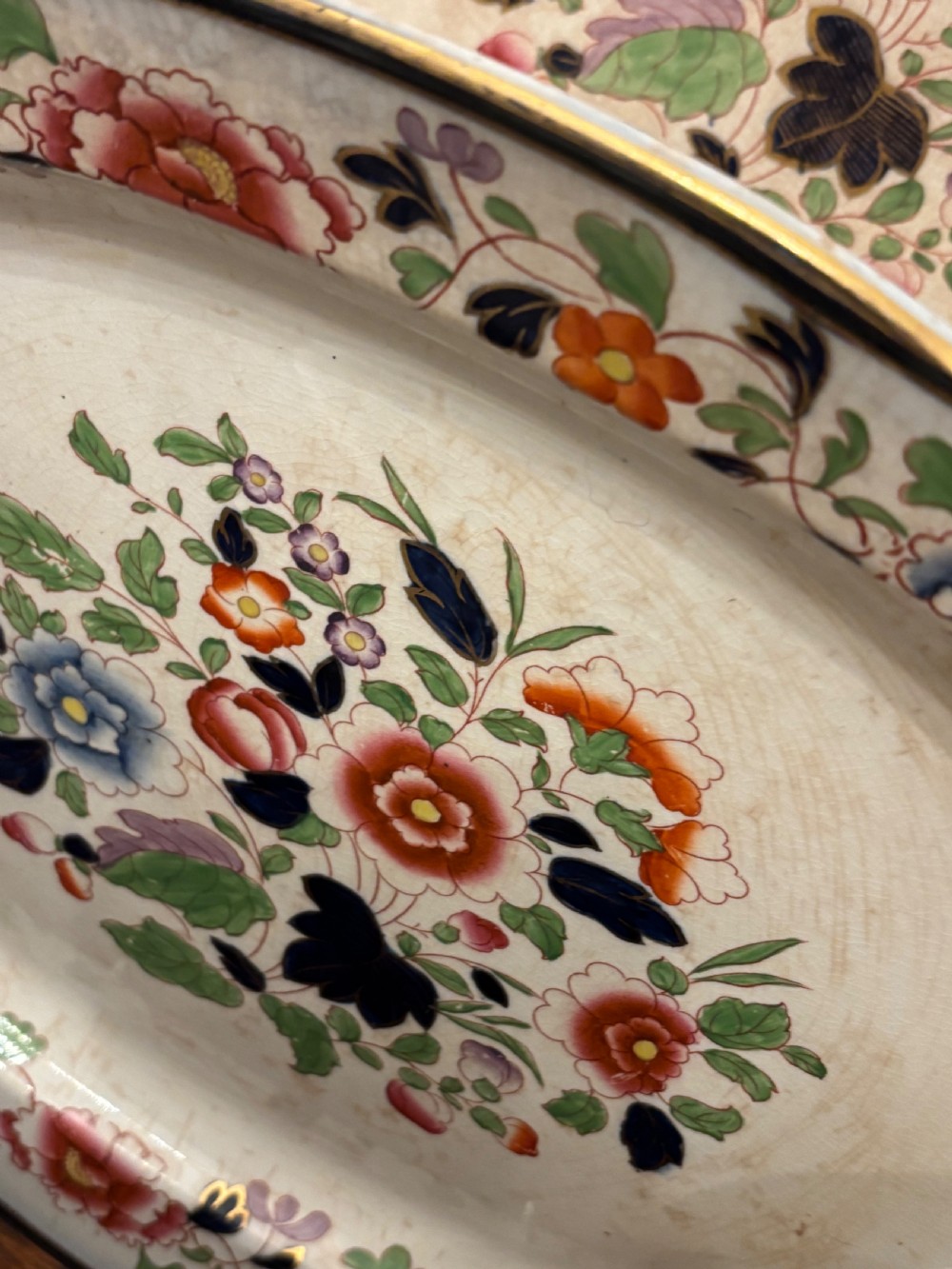 An extensive antique ceramic dinner service featuring floral transfers, matching tureens, bowls, and serving platters arranged together. View IV