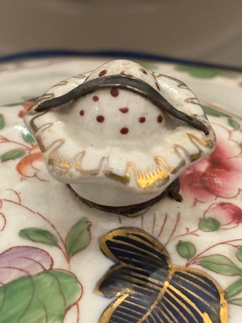 An extensive antique ceramic dinner service featuring floral transfers, matching tureens, bowls, and serving platters arranged together. View V