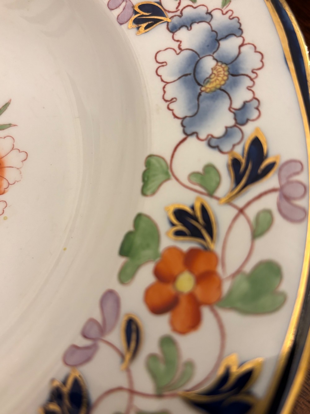 An extensive antique ceramic dinner service featuring floral transfers, matching tureens, bowls, and serving platters arranged together. View VII